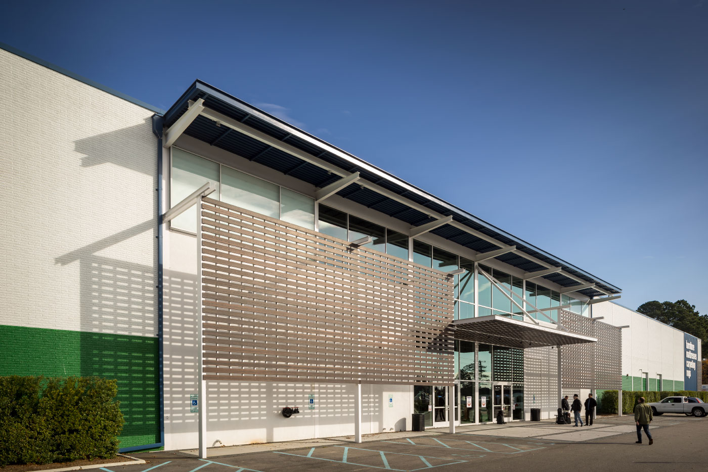 Close-up View of Wood Louvers, Wood Trellis, Wood Siding and Glass and Steel Entrance for the Renovation of the Haynes Virginia Beach Showroom by Green and Modern Virginia-based HEDS Architects.