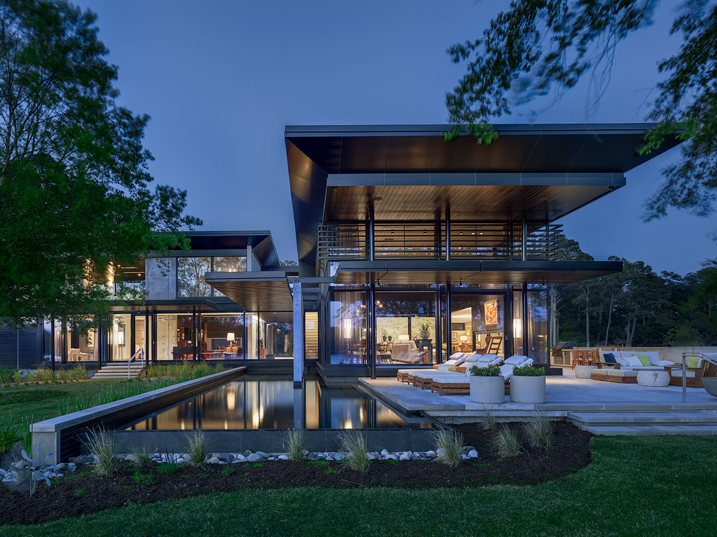 Modern and Green Virginia Beach Home on Linkhorn Bay with Deep Overhangs, Lap Pool, Triple Pane Windows, Shou Sugi Ban Wood Siding Dark Stained Trellis, Concrete Walls and Piers, Concrete Paving, Steel Structure and Reynobond Metal Panels by Virginia Beach Architect Allison Ewing.